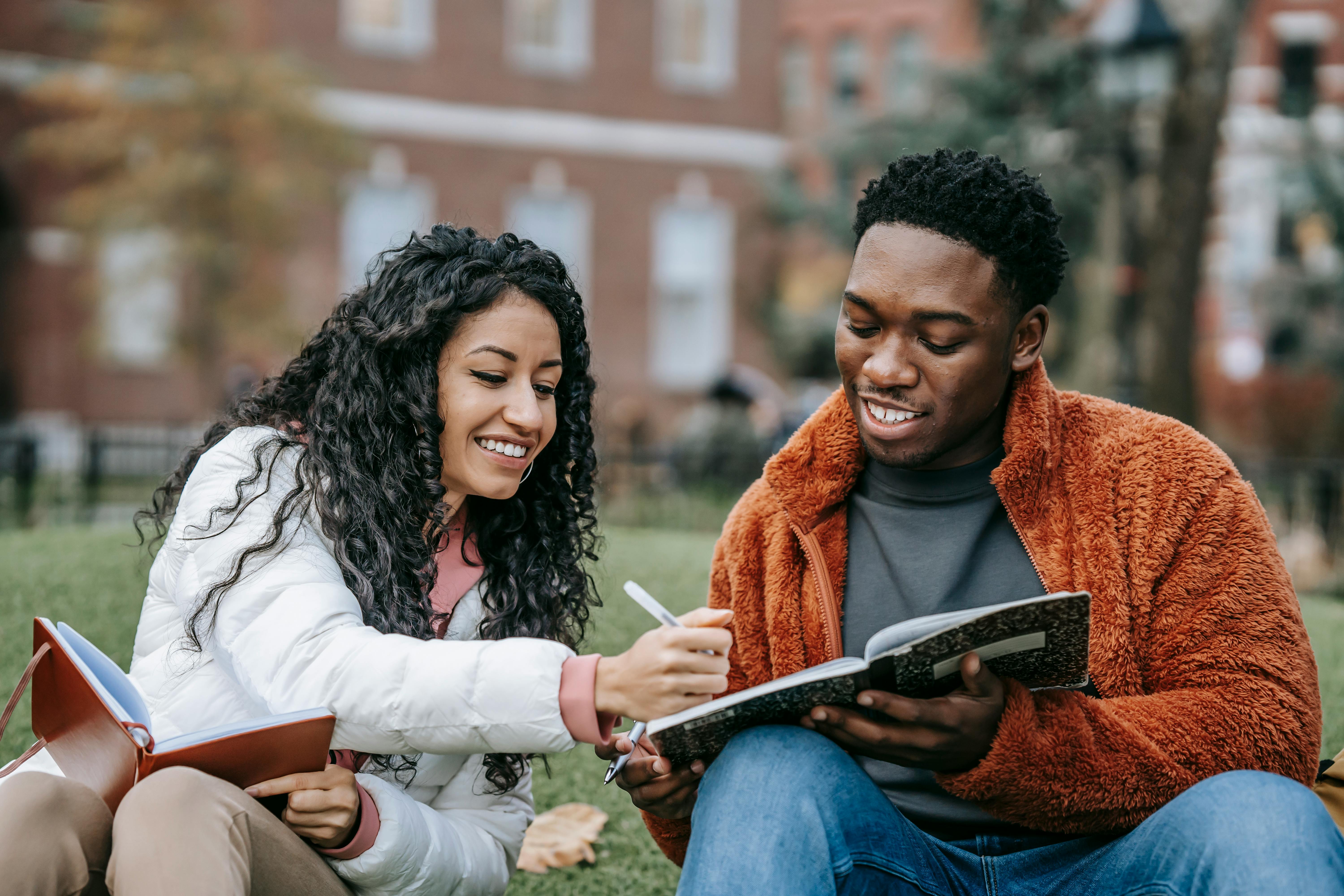 Two college students studying outside