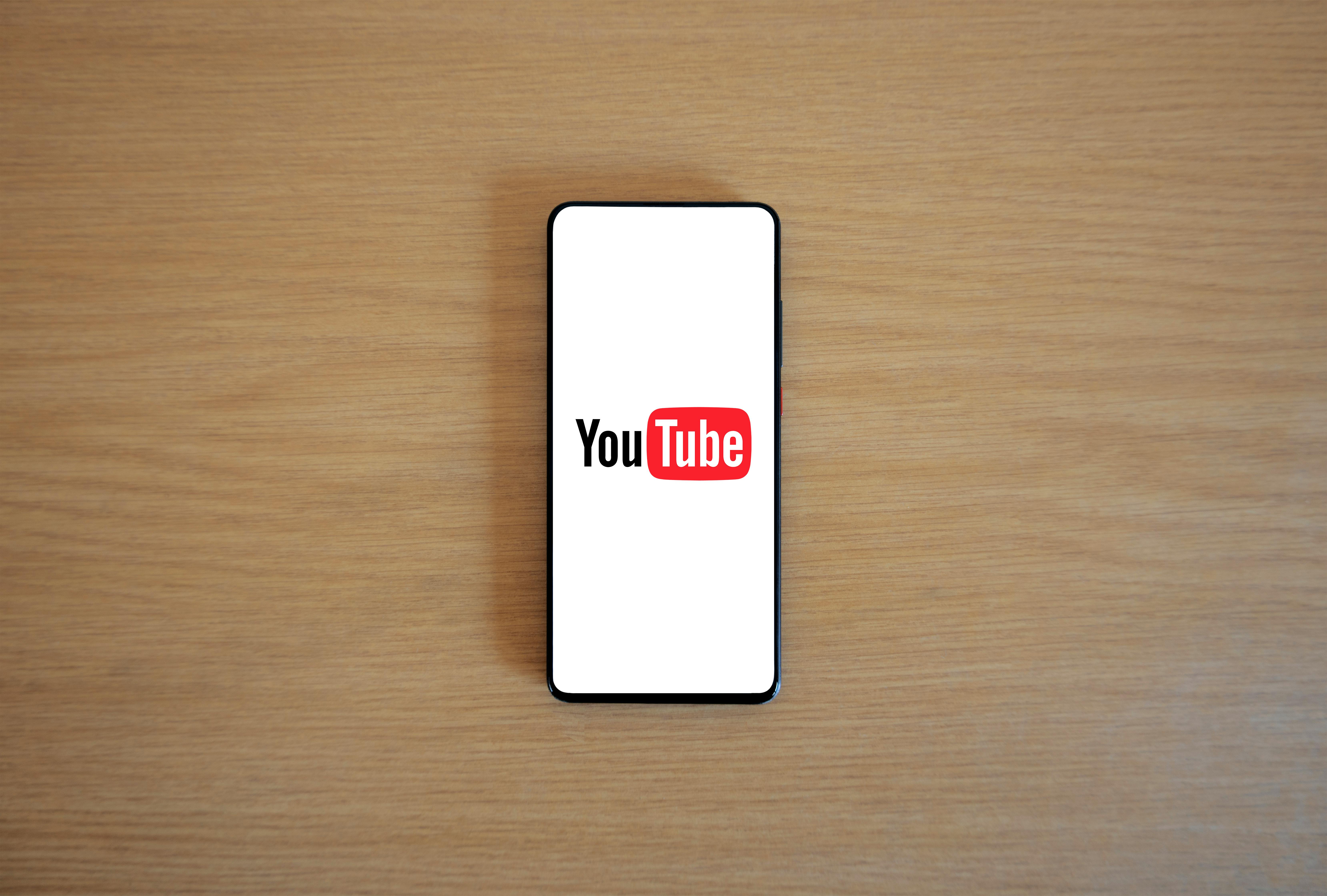 A cell phone with the YouTube logo on it